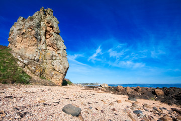 Rocky coastal scene with blue sky