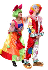 Two clown-girls in wigs and fancy costumes
