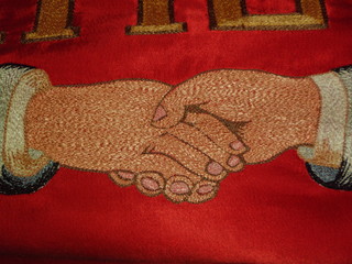 Shaking hands (detail of old fire brigade's flag)