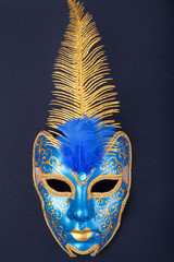 blue and gold mask on a black background