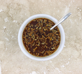 Onion soup in white bowl with spoon