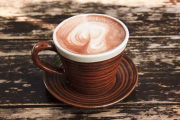 brown cup of hot chocolate with creamy milk