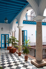 A view of colonial building interior with tropical flowers