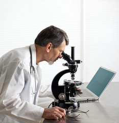 Doctor or Scientist at the Microscope