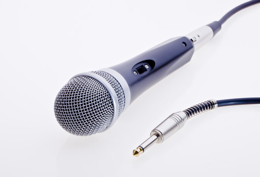 Black microphone with jack plug on a white background