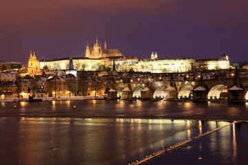 Fototapeta na wymiar Snowy Prague gothic Castle with Charles Bridge in the Night