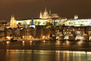 Fototapeta na wymiar Snowy Pradze gotyckiego zamku z mostu Karola w nocy