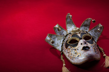 ornate carnival mask over red background