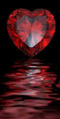 Red heart shaped garnet isolated reflected on water