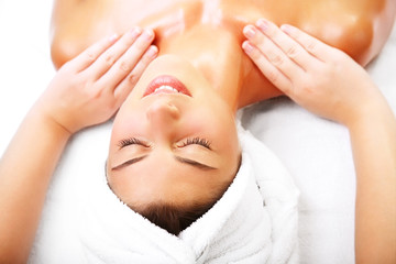 Obraz na płótnie Canvas Close-up of a beautiful smiling woman getting a massage.