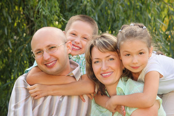 Fototapeta premium son is embracing father and daughter is embracing mother