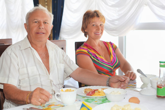 Smiling Elderly Married Couple Having Breakfast At Restaurant