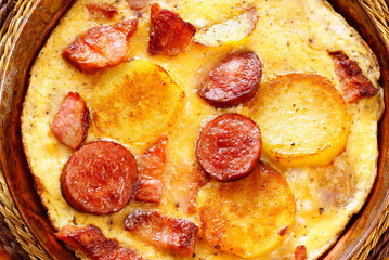 Omelet with bacon, sausage and potatoes