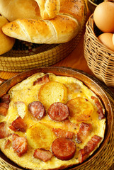 Omelet with bacon, sausage and potatoes