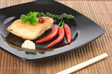 Served fried fish with chili pepper and horseradish souce