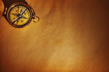 Fototapeta na wymiar Antique brass compass over old background