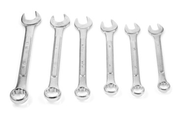 Organized set of chrome spanners or wrenches in a white backgrou