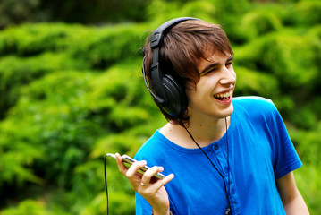 happy teenage boy in headphones