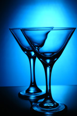 two coctail glasses on a blue