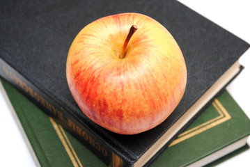 red apple on snack of books