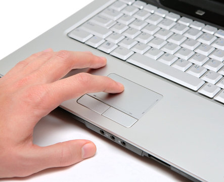 hand working on a laptop touchpad