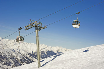 Fototapeta premium Cabin car over snowy mountain
