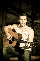 Obraz premium Man is playing a guitar