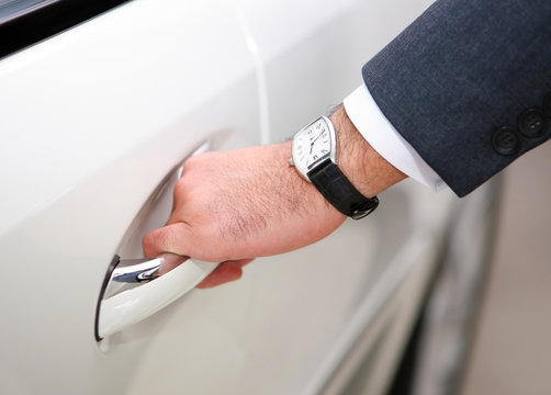 man's hand opening luxury car door