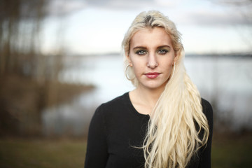Fototapeta na wymiar Young woman next to lake.