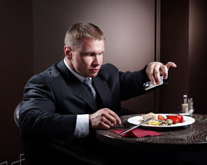 Muscular businessman eating