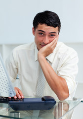 Fototapeta premium Bored young businessman at his desk