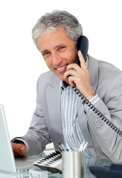 Smiling mature businessman talking on phone