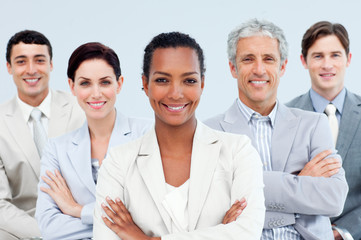 Diverse business people standing with folded arms