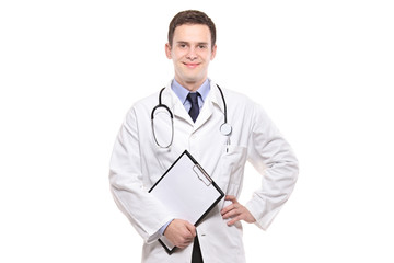 Fototapeta premium Portrait of a young male doctor against white background