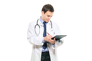 A young male doctor writing down notes against white background