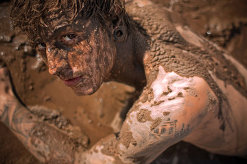 young guy full with mud
