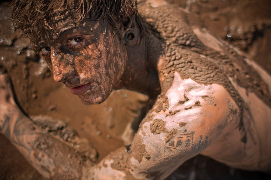 young guy full with mud