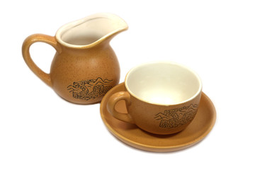 Chinese tea cup with saucer and brown milk can isolated on white