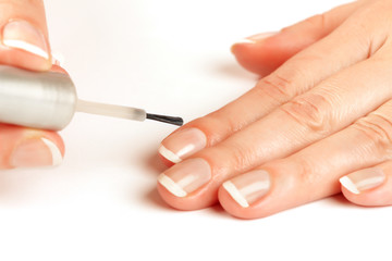 Manicurist applying natural looking nail polish