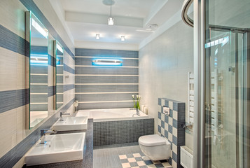 Modern bathroom in blue and gray tones with mosaic