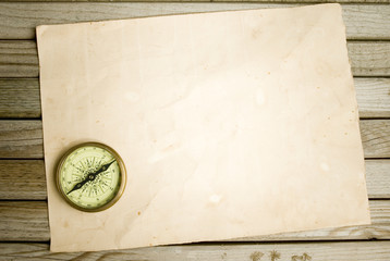 compass and old paper on wood background