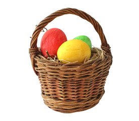 Painted Easter eggs in basket on white background
