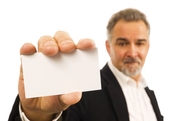 Mature businessman holds a blank business card in his hand