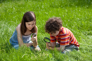 Kids looking through magnifying glass