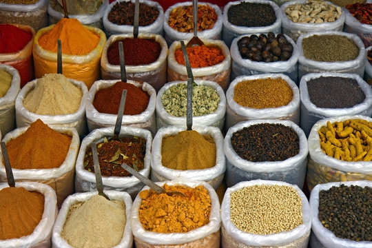 many colorful spice in small bags and spoons