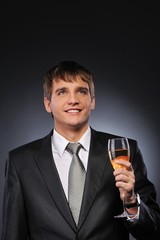 Young handsome businessman with a glass of champagne
