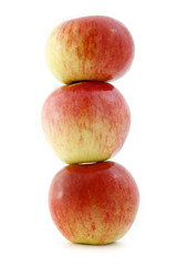 three balanced apples