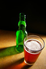 pint of draft beer and green bottle