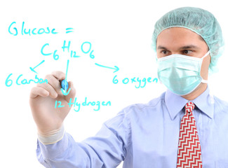 A chemist researcher writing formula on glass