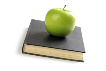 green apple on book